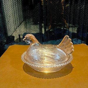 Vintage hen sitting on nest dish